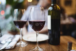 wine glasses on a table with plates