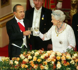Queen Elizabeth II and Mexico's President Felipe Calderon (L) toast their glasses during a state banquet hosted by the Queen in honour of the visiting president and first lady, inside the Ballroom at Buckingham Palace