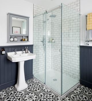 bathroom with shower and design tiles