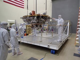 The Mars lander gets lifted from the base of a storage container on June 20, 2017, at Lockheed Martin.