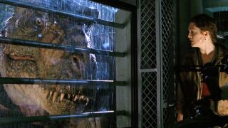 Scene from the movie The Lost World: Jurassic Park. Here we see a T-rex staring through a barred window whilst a Dr Harding hides inside.