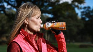 Female golfer sipping energy drink