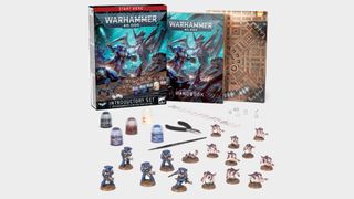 Warhammer 40,000 Introductory Set with models, box, and book laid out