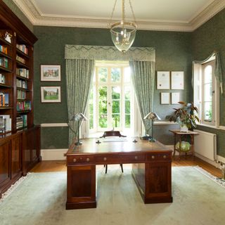 library area with curtains on window and lamps on table with bookcase