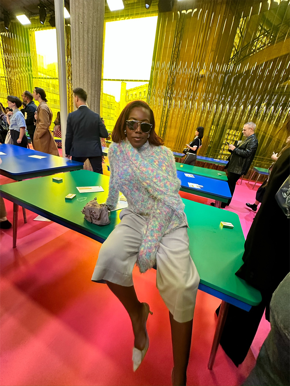 Tiffany Reid wearing a multicolor sweater with capri pants during fashion month.