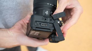 Close up of the ports on a Nikon Z6 III camera held in a pair of hands