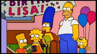 Lisa in the middle of her family in The Simpsons