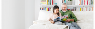 A parent reads with their sibling