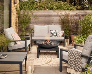 patio with fire pit and dobbies furniture
