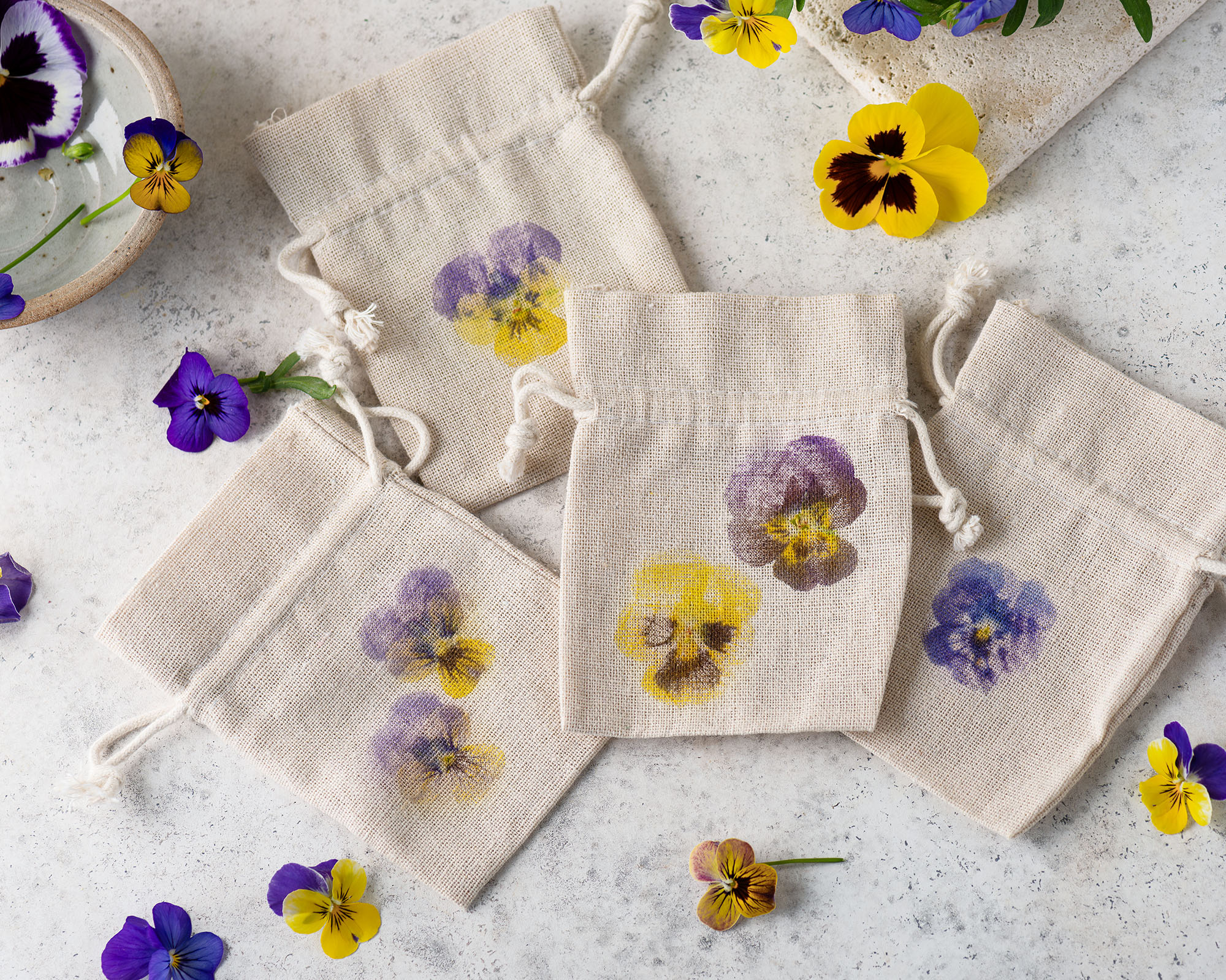 Top view of the small handmade fabric bags with hammered flower prints.
