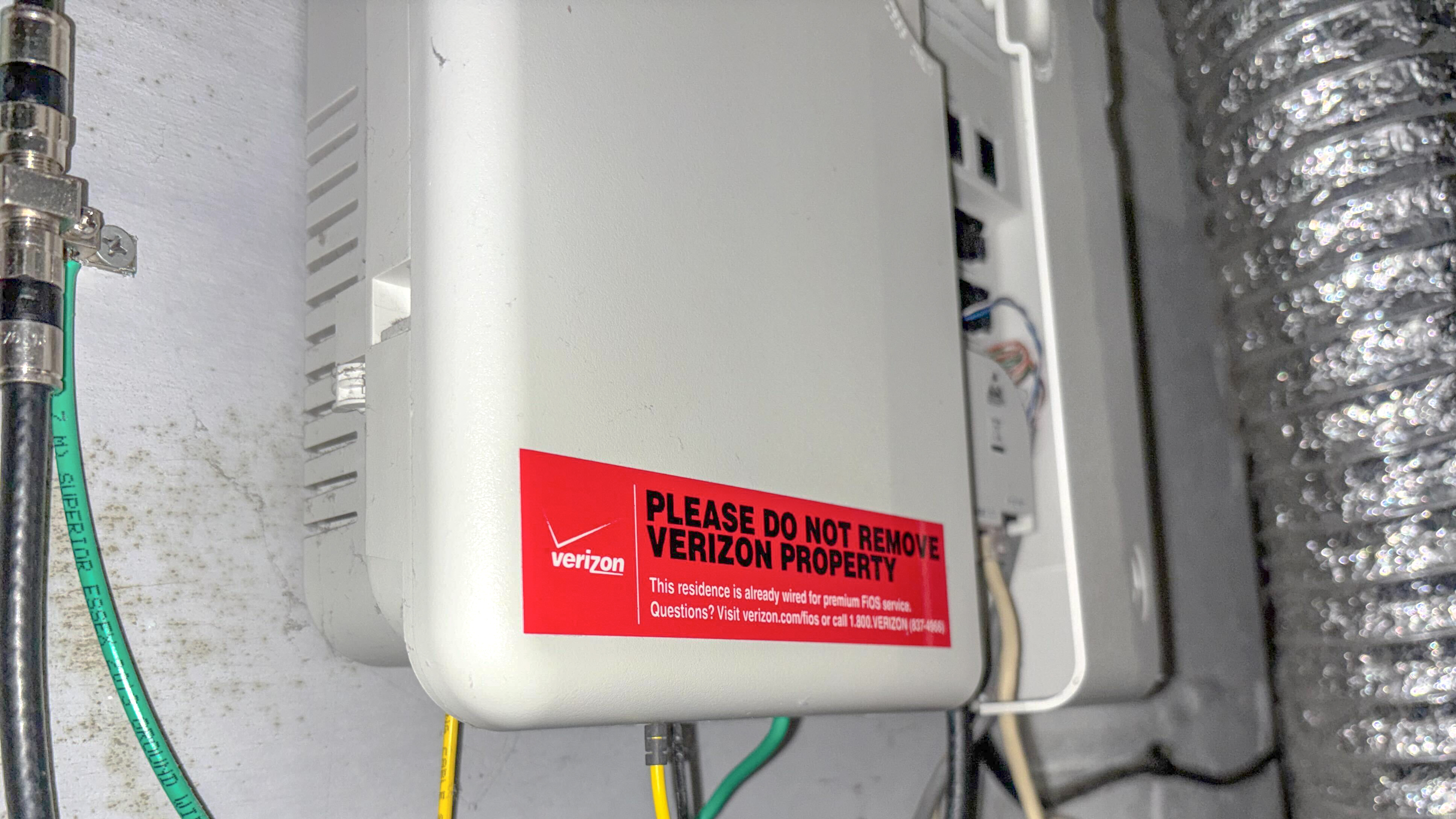 The small print on Verizon Fios' ONT box installed in a basement