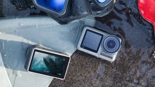DJI Osmo Action camera photographed next to some scuba diving gear