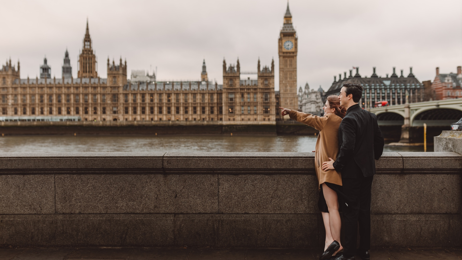 Stylish Young Couple Enjoying a Blissful Moment in London and Young Man Pointing somewhere