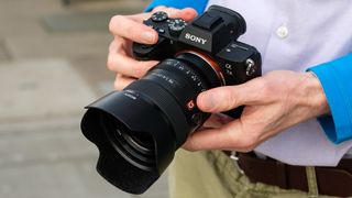 The Sony A7 III camera held in a person's hands