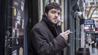 Tom Burke smoking cigarette in BBC series Strike
