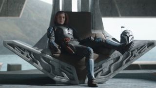 Katee Sackhoff as Bo-Katan sitting on a throne.