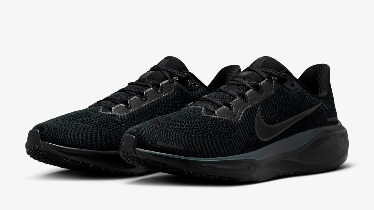 Pair of black Nike trainers on light gray background