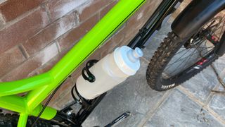Bottle going into the Elite Prism bottle cage on a mountain bike