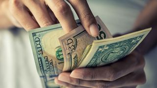 Close-up hands counting money American dollars