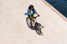 A woman rides an e-bike