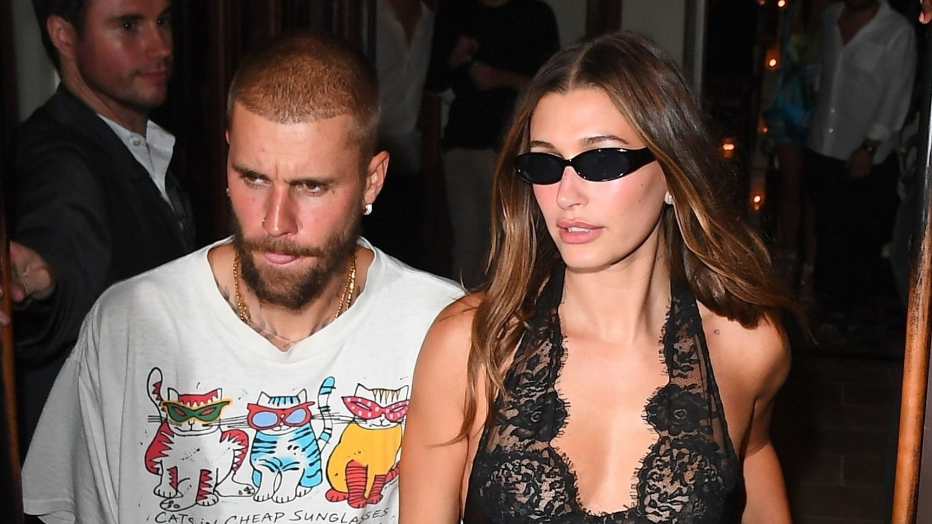 Hailey Bieber wearing a black lace Saint Laurent mini dress
