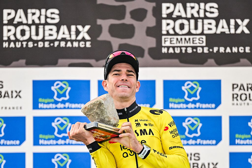 Wout van Aert lifts the cobblestone trophy above is head as the winner of the 2026 Paris-Roubaix