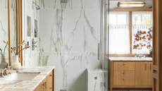 A shower area built with marble walls and marble bench