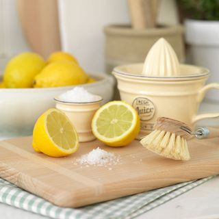 lemon and salt on wooden board
