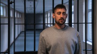 Showtrial season 2 ending - Justin in prison wearing a grey tracksuit