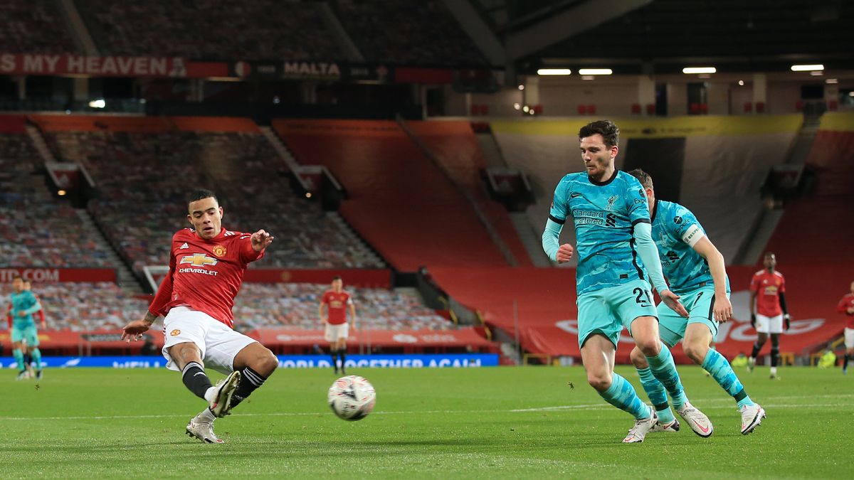 Mason Greenwood of Manchester United shoots past Andrew Robertson of Liverpool 