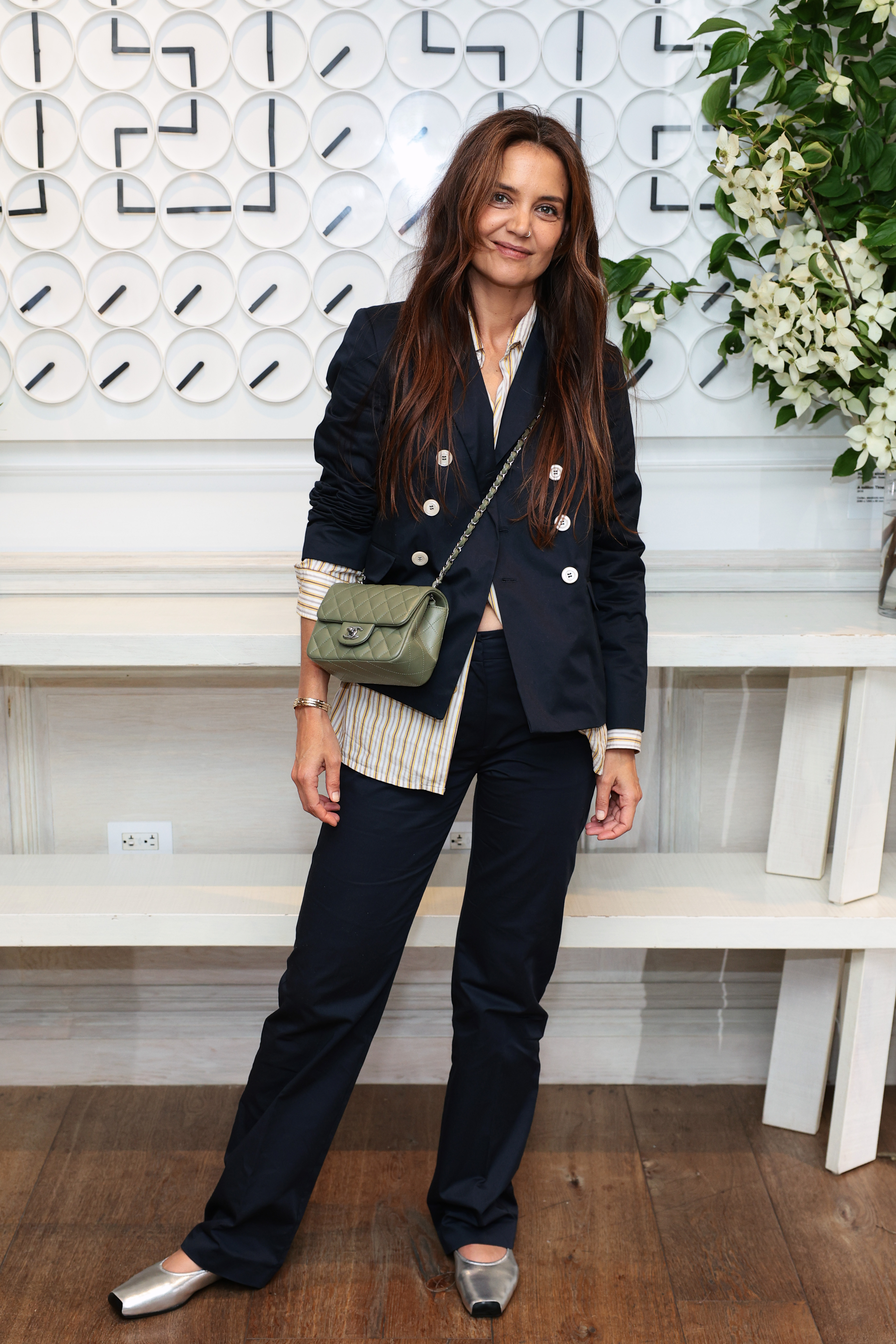 An image of Kaite Holmes wearing silver flats.