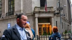 People on Wall Street walk past the New York Stock Exchange on April 11, 2025. 