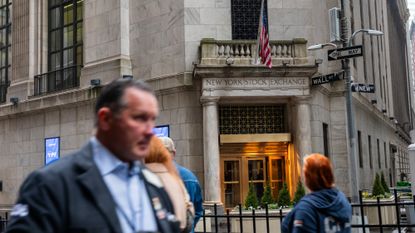 People on Wall Street walk past the New York Stock Exchange on April 11, 2025. 