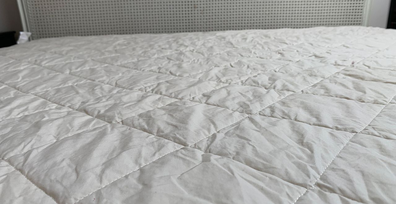 Bed with Woolroom Deluxe Washable Mattress protector on the mattress