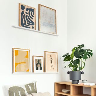 White living room with two picture rails with a collection of prints