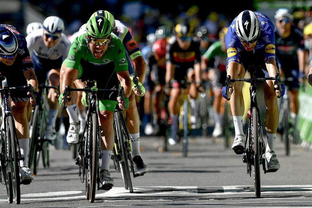 Stage winner Team Deceuninck Quicksteps Mark Cavendish of Great Britain wearing the best sprinters green jersey crosses the finish line at the end of the 13th stage of the 108th edition of the Tour de France cycling race 219 km between Nimes and Carcassonne on July 9 2021 Photo by Philippe LOPEZ AFP Photo by PHILIPPE LOPEZAFP via Getty Images