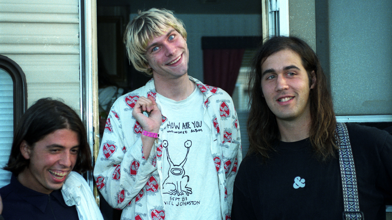 Nirvana outside their trailer gurning at the camera in 1992