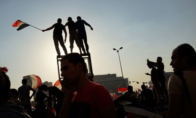 People dance and cheer in Tahrir Square the day after former Egyptian President Mohammed Morsi was ousted from power.