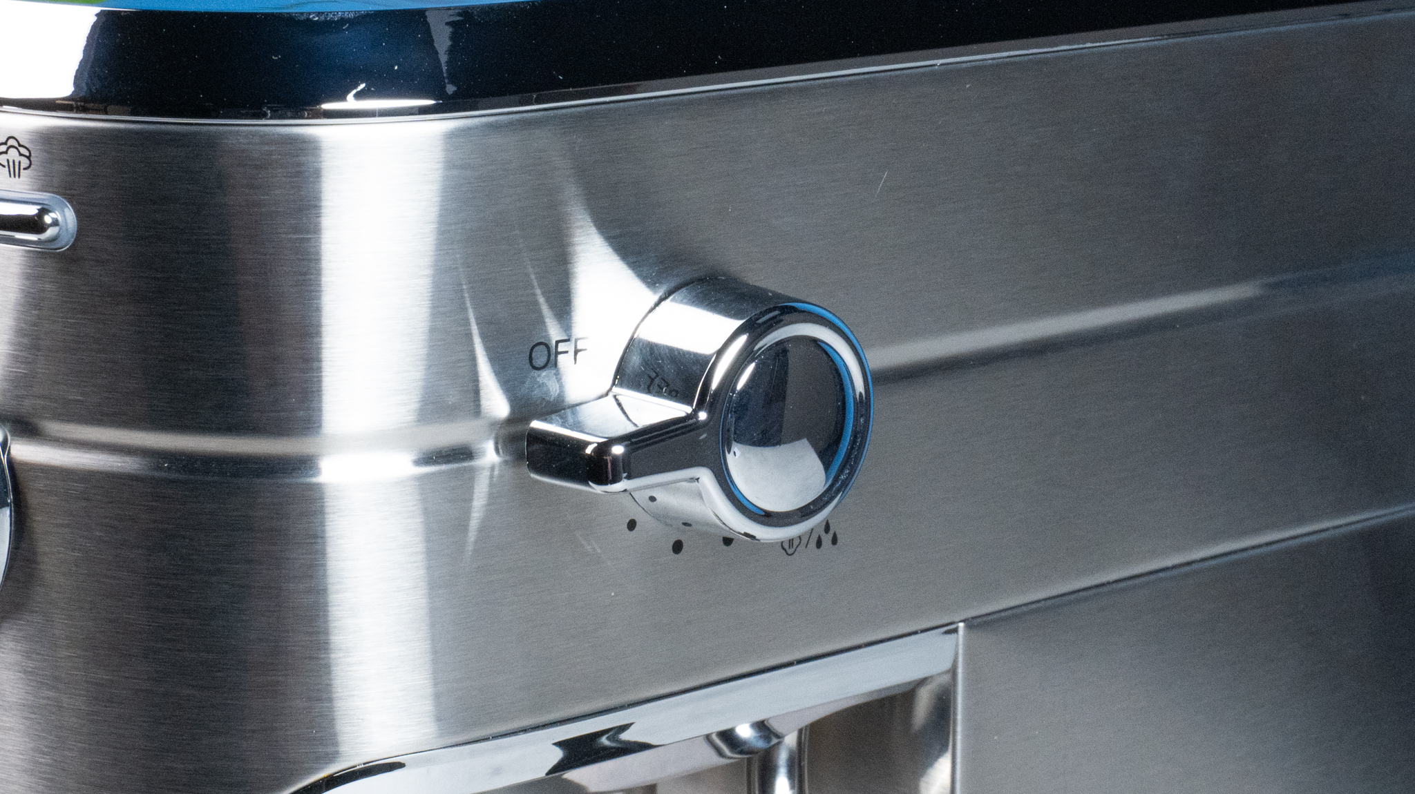 The Casabrews 5418 Pro espresso machine in stainless steel with a steam wand on the right side and three buttons on the front of the machine and a pressure gauge underneath