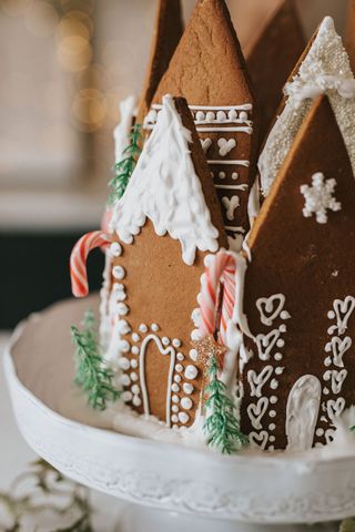 close up of the complete gingerbread house with candy canes