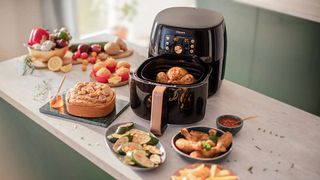 Philips Airfryer XXL on bench surrounded by food