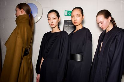 3 models wearing fluid black dresses