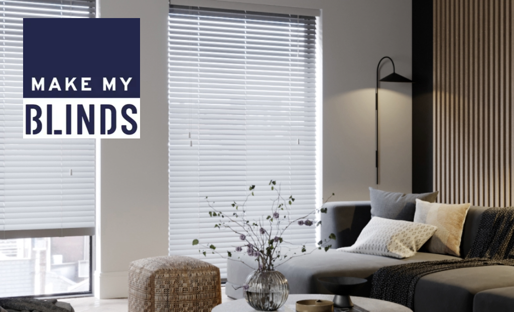 Living room with light grey blinds and Make My Blinds logo in the top left corner