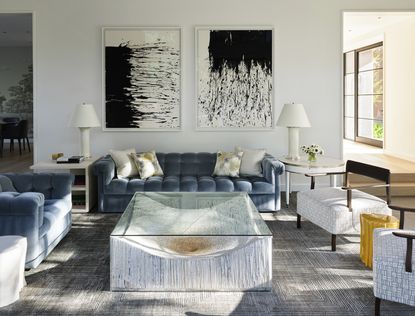 neutral living room with modern coffee table and large modern art