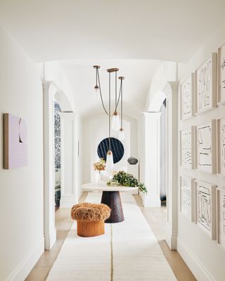 Long entryway rug with a tan stripe and neutral hall table