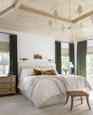 Luxury bedroom with neutral scheme and green velvet curtains