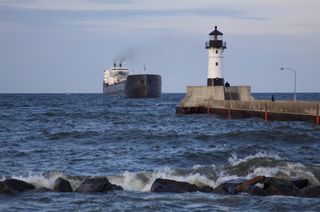 A ship approaches the Duluth Pier Lighthouse. Lake Superior is a major shipping hub.