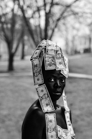 Photograph of a person with a headpiece made out of dollar bills by photographer Zanele Muholi, on display at Photo 2021 Melbourne.