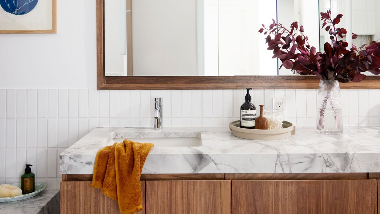 a white bathroom with a marble look countertop