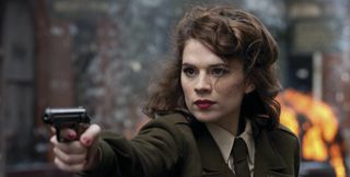 Hayley Atwell holding gun as Peggy Carter